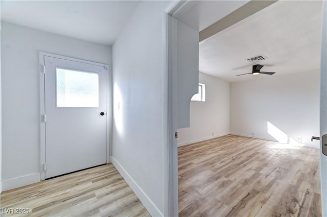 foyer entrance with light wood-style flooring, visible vents, ceiling fan, and baseboards