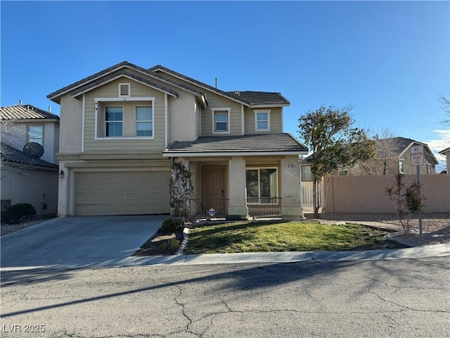 view of front facade with an attached garage, fence, concrete driveway, a tiled roof, and stucco siding