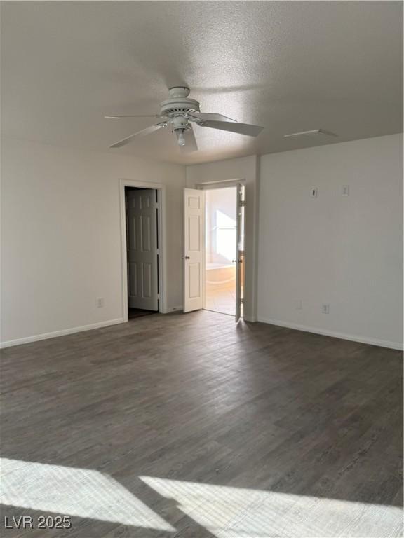 spare room with ceiling fan, a textured ceiling, baseboards, and wood finished floors