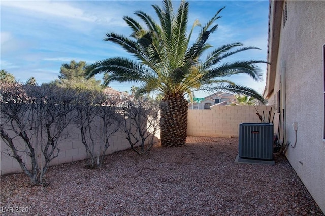 view of yard featuring a fenced backyard and central air condition unit