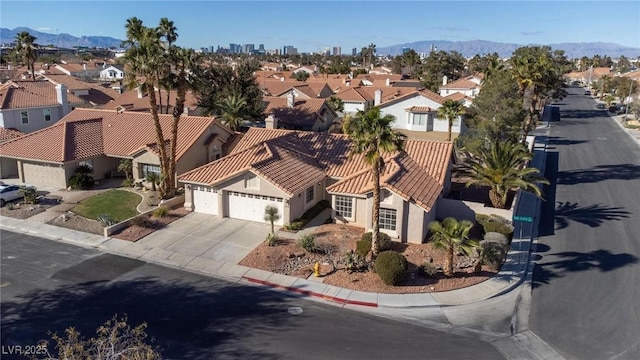 drone / aerial view featuring a residential view and a mountain view