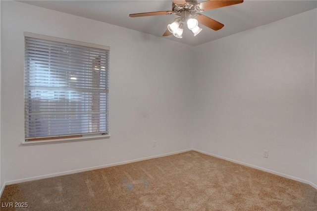 empty room with ceiling fan, baseboards, and carpet flooring