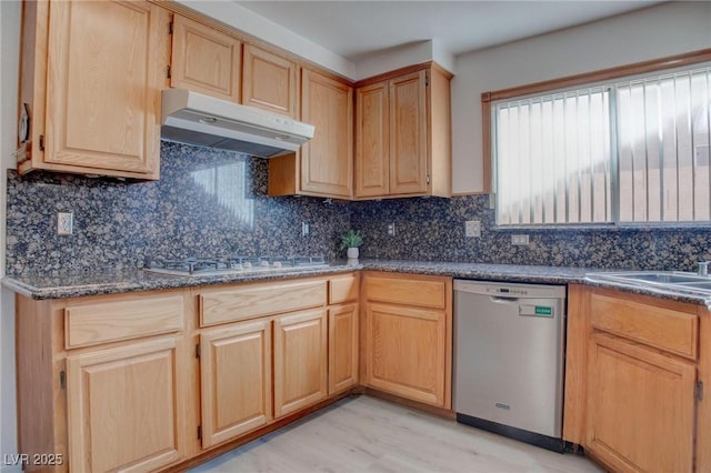 kitchen with white gas stovetop, dishwasher, under cabinet range hood, light brown cabinets, and a sink