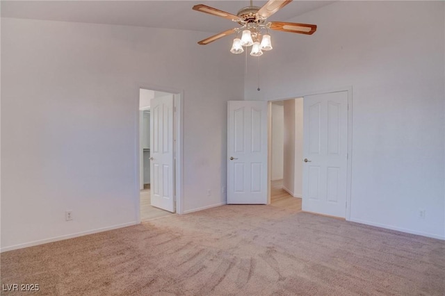 unfurnished bedroom featuring a closet, carpet flooring, ceiling fan, high vaulted ceiling, and baseboards