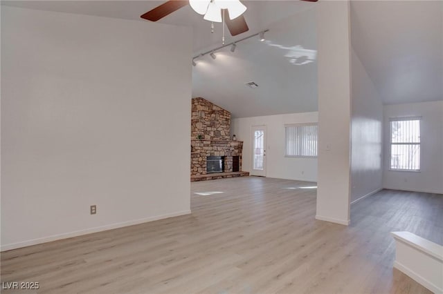 unfurnished living room with a fireplace, wood finished floors, and baseboards