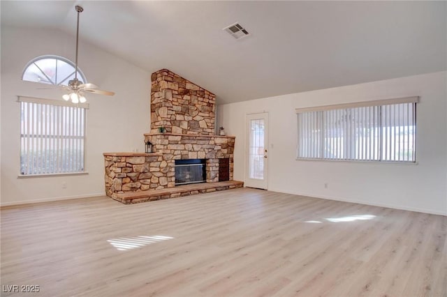 unfurnished living room with a wealth of natural light, a fireplace, and wood finished floors