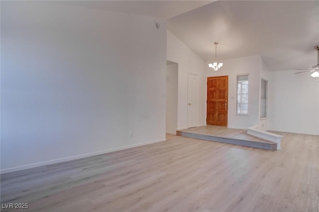 entrance foyer with baseboards, high vaulted ceiling, ceiling fan with notable chandelier, and light wood-style floors