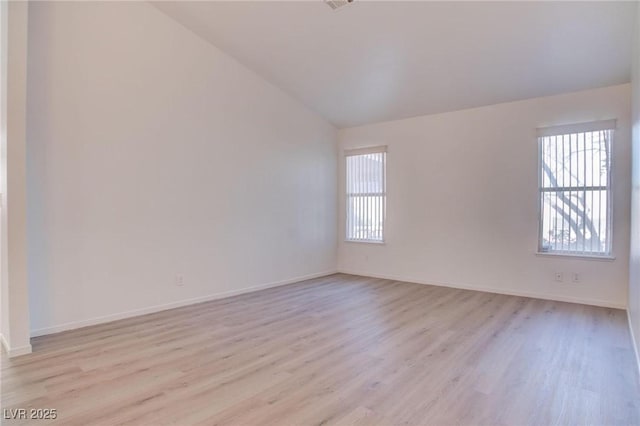 unfurnished room with light wood-type flooring, a healthy amount of sunlight, and baseboards