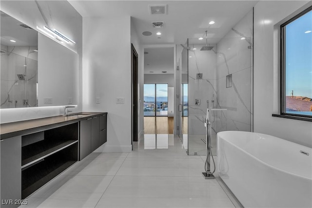 full bathroom featuring a marble finish shower, visible vents, and vanity