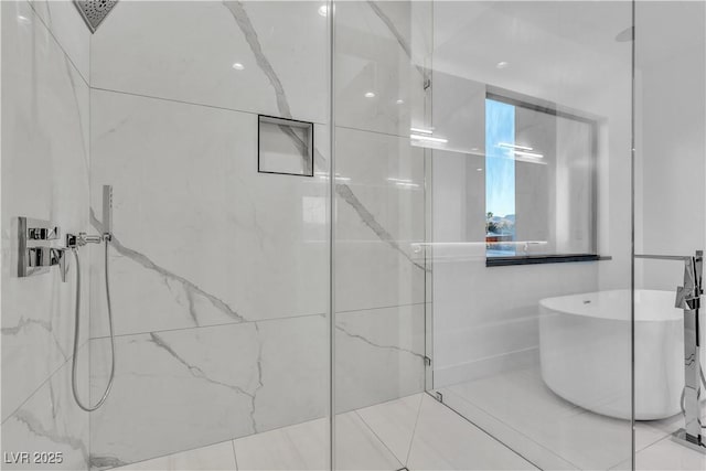 full bathroom with a soaking tub and a marble finish shower