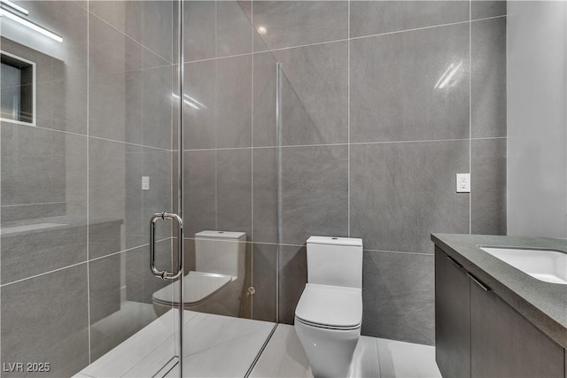 full bathroom featuring toilet, a stall shower, tile walls, and vanity