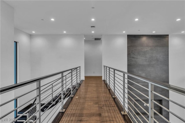 hall with baseboards, visible vents, wood finished floors, and recessed lighting