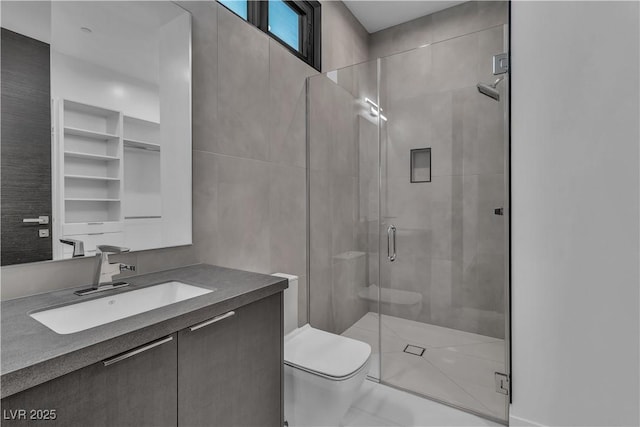 full bathroom featuring a stall shower, vanity, and toilet