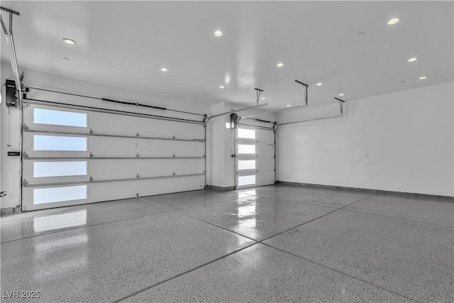 garage featuring recessed lighting and baseboards