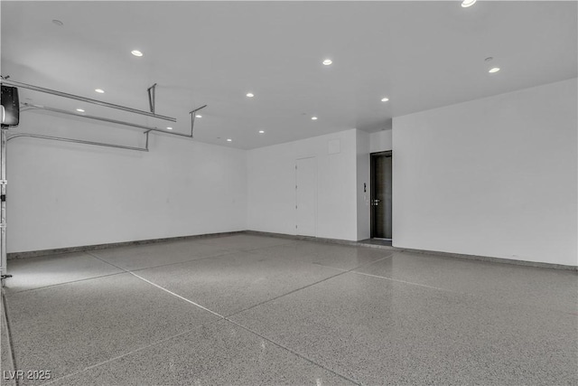 garage featuring baseboards and recessed lighting