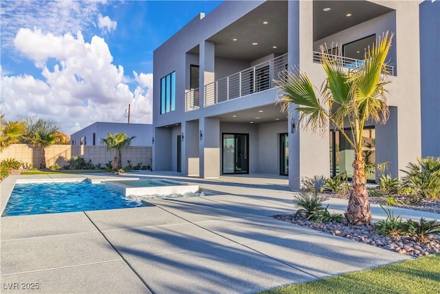 view of pool with a fenced in pool, fence, a patio, and an in ground hot tub