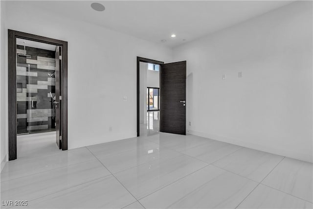 tiled spare room with recessed lighting