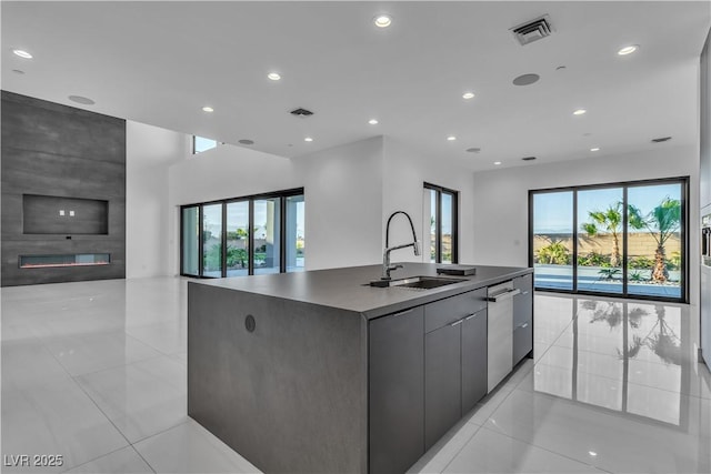 kitchen with open floor plan, plenty of natural light, a sink, and visible vents