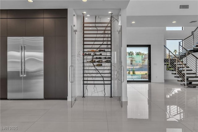 interior space featuring recessed lighting, visible vents, stairway, and light tile patterned floors