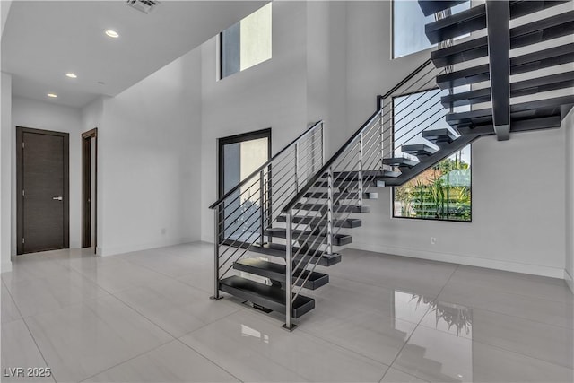 2827 Richmar Ave, Henderson, NV 89074 - stairway featuring baseboards, visible vents, a high ceiling, and recessed lighting