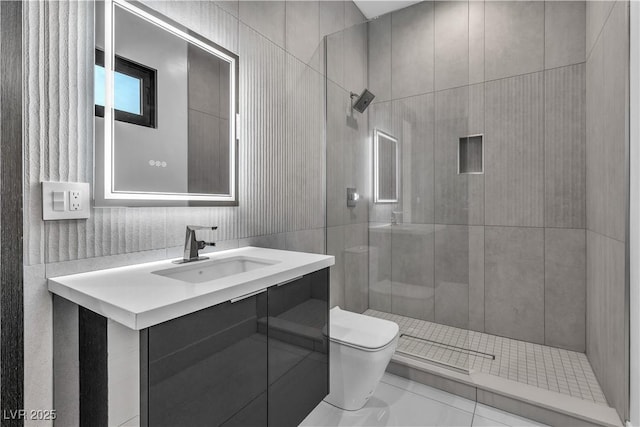 full bathroom featuring tile walls, a tile shower, vanity, and toilet