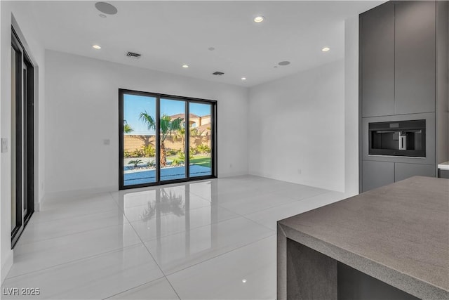 living area with light tile patterned flooring, baseboards, visible vents, and recessed lighting