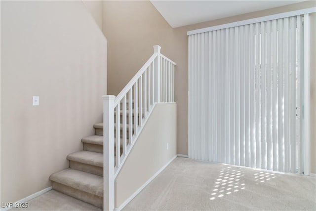 stairway with carpet floors and baseboards