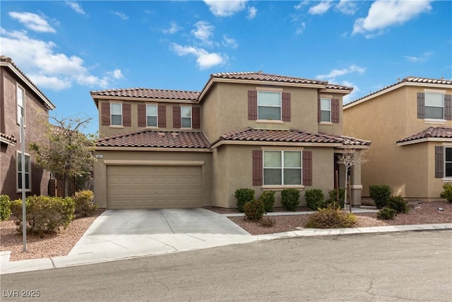 mediterranean / spanish house featuring concrete driveway, a tiled roof, an attached garage, and stucco siding