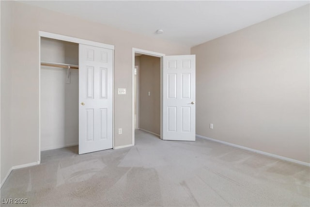 unfurnished bedroom featuring carpet floors, baseboards, and a closet