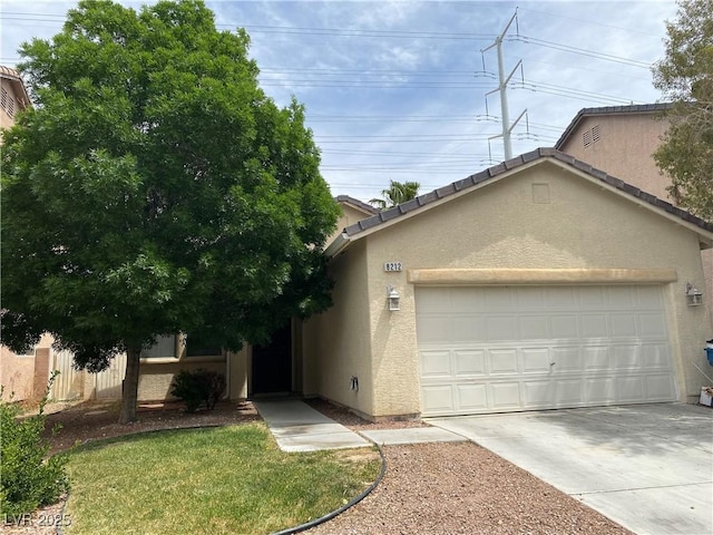 ranch-style house with driveway, a tiled roof, an attached garage, and stucco siding