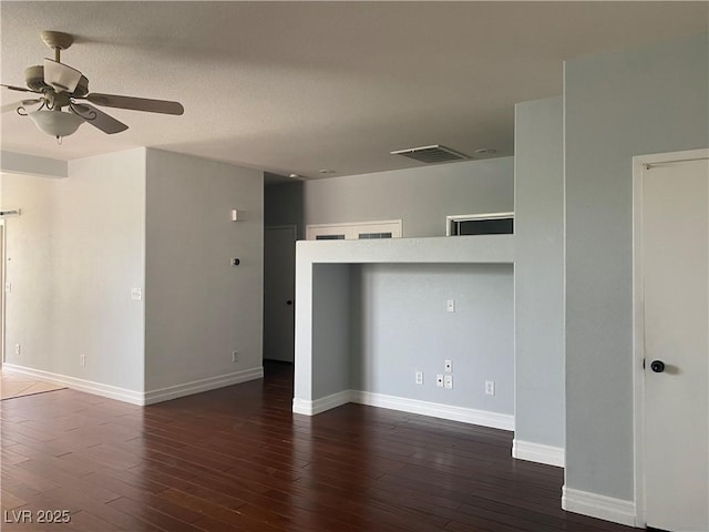 interior space featuring baseboards, ceiling fan, visible vents, and hardwood / wood-style floors