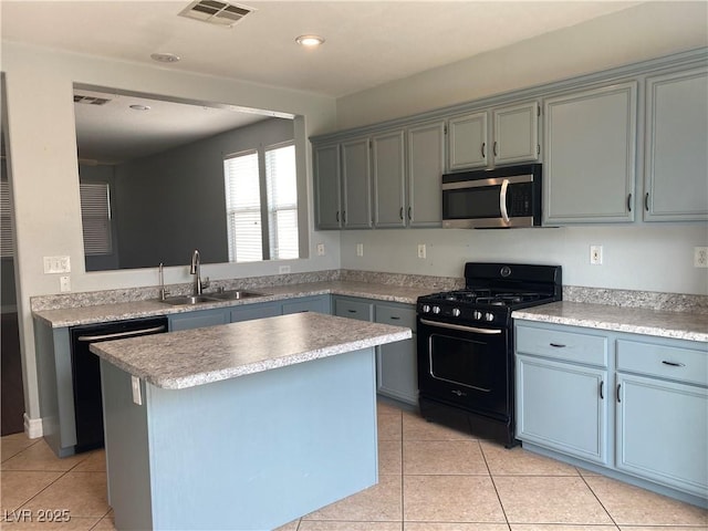 kitchen featuring dishwashing machine, a sink, visible vents, black gas stove, and stainless steel microwave