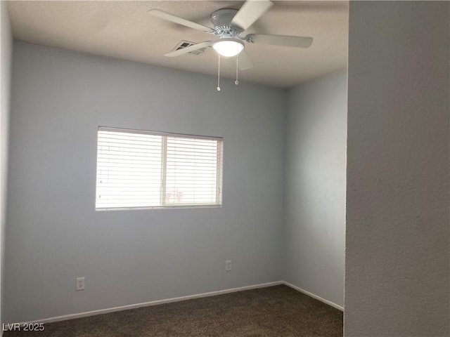 empty room with ceiling fan, visible vents, baseboards, and dark colored carpet