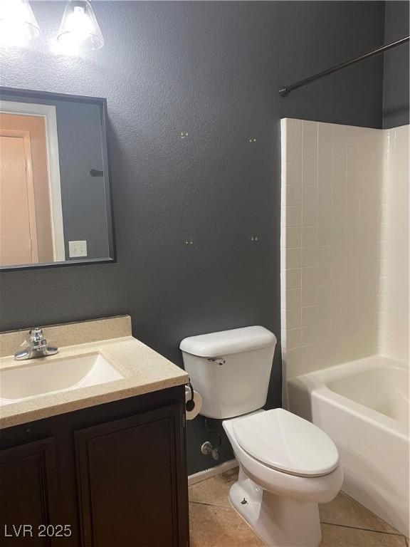 full bath featuring shower / washtub combination, tile patterned flooring, vanity, and toilet