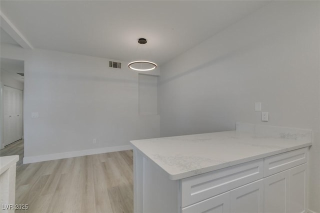 spacious closet featuring light wood finished floors and visible vents