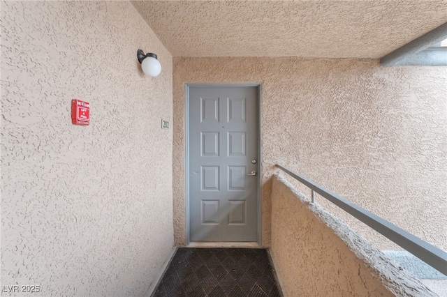 entrance to property featuring stucco siding