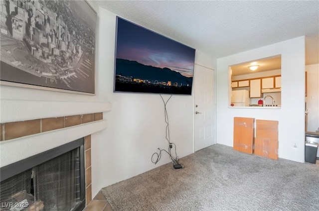 living area featuring a fireplace with flush hearth and carpet floors