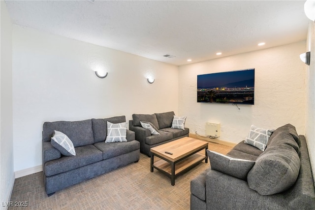 living area with baseboards, visible vents, and recessed lighting