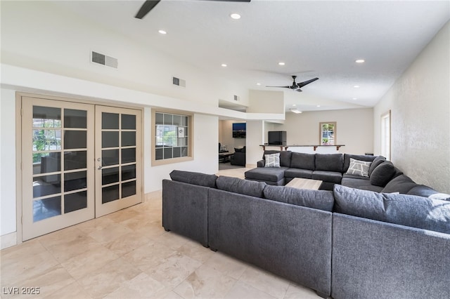 living area featuring visible vents, ceiling fan, and a healthy amount of sunlight