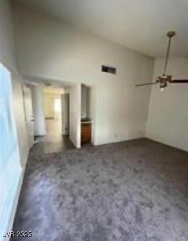 unfurnished living room featuring vaulted ceiling