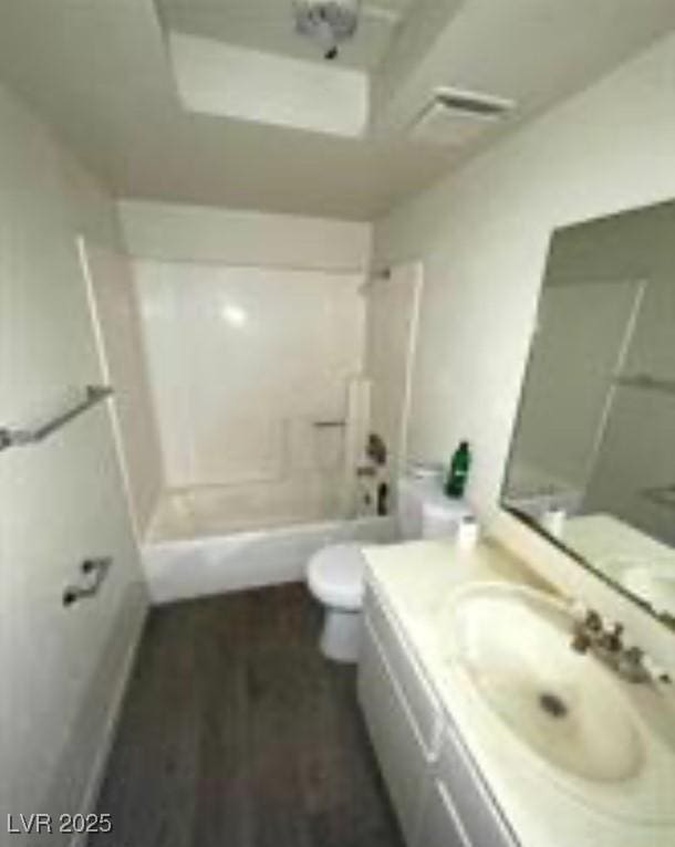 full bath featuring vanity, toilet, and bathing tub / shower combination