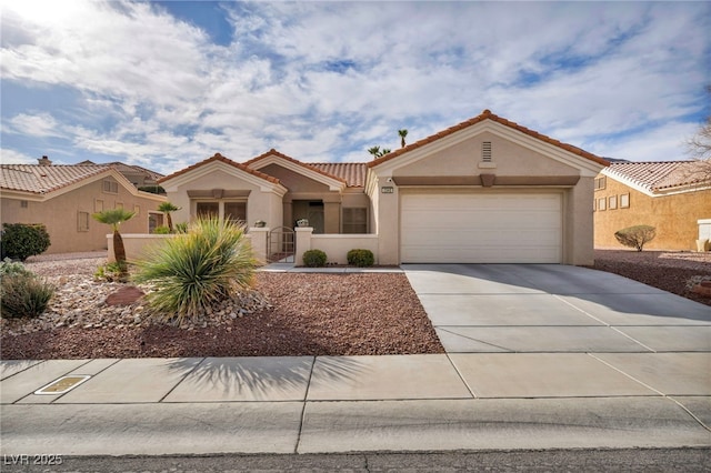 view of front of house with stucco siding, concrete driveway, an attached garage, fence, and a tiled roof