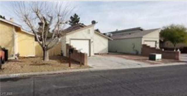 mid-century modern home with driveway and central AC unit