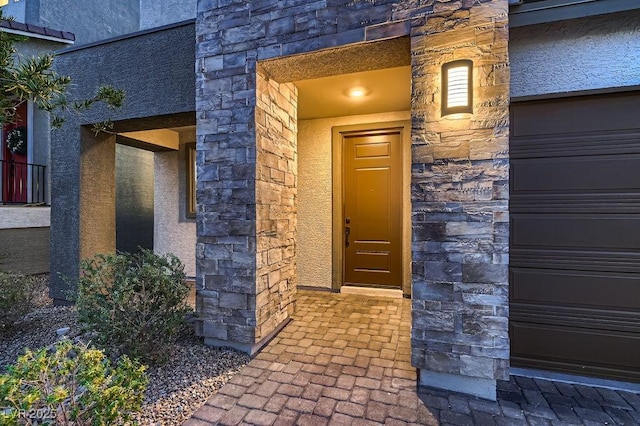 entrance to property with stone siding and stucco siding