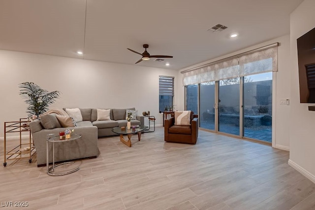 living room featuring recessed lighting, visible vents, baseboards, a ceiling fan, and light wood finished floors