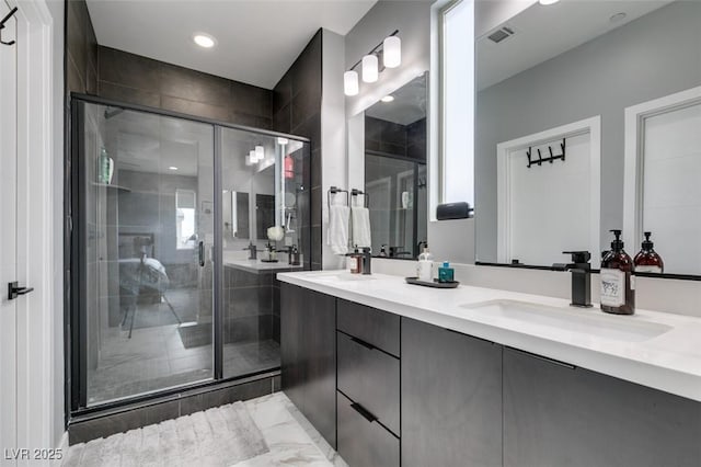 bathroom featuring double vanity, a sink, visible vents, and a shower stall