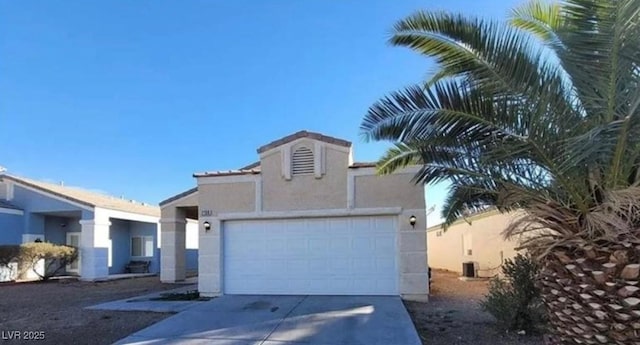 view of front of home with a garage, driveway, and stucco siding