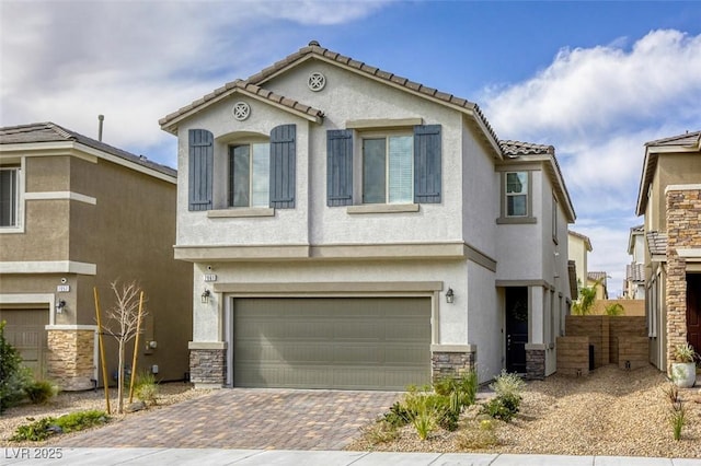 view of front of property featuring decorative driveway, a garage, and stucco siding