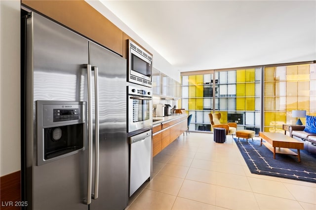 kitchen with appliances with stainless steel finishes, modern cabinets, and tile patterned floors