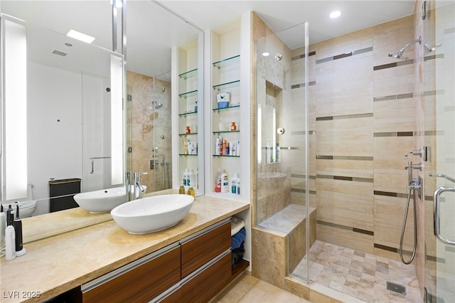 bathroom featuring a shower stall, vanity, and tile patterned floors